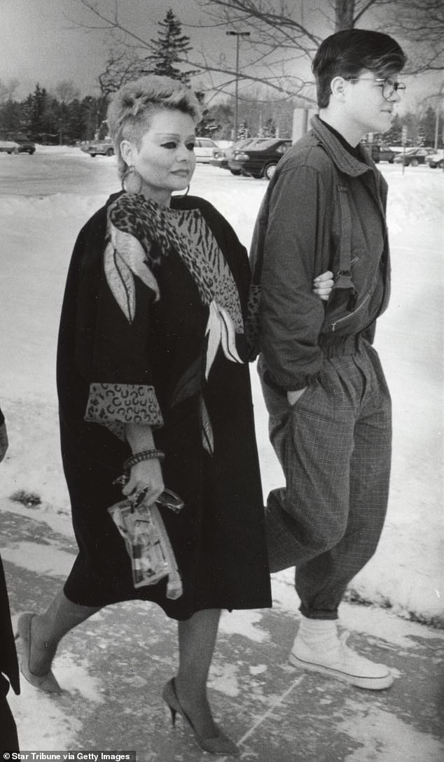 Tammy Faye Bakker holds her son Jamie Bakker's arm as they walk to the prison in Rochester, Minnesota, to visit her husband, former televangelist Jim Bakker, in 1989