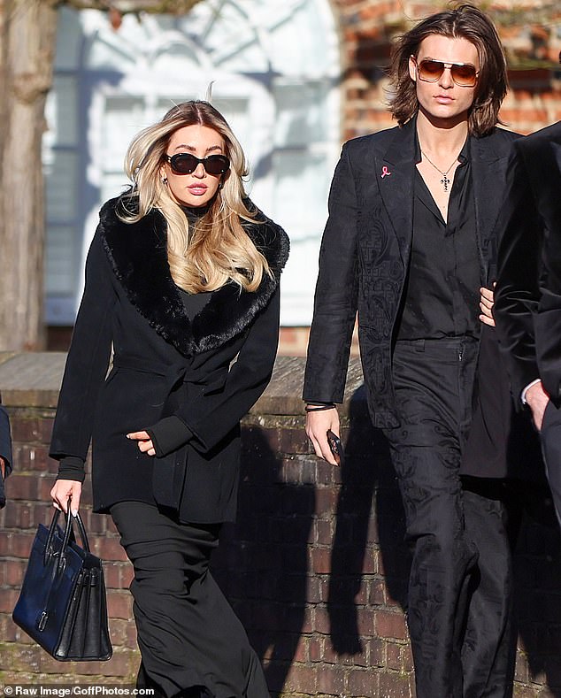 Liam Payne's girlfriend Kate Cassidy, 25, arrives at the church today for the singer's funeral alongside Damian Hurley, 22.