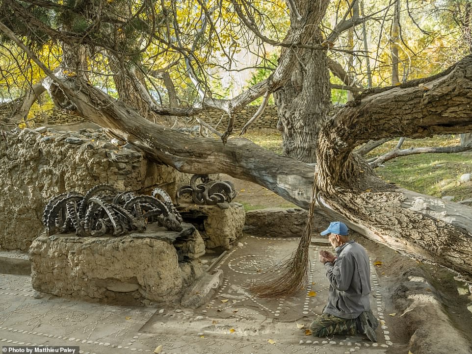 This thought-provoking image shows a shrine in an area with a rich history of Animism, Zoroastrianism and Buddhism maintained by the local Wakhi people, who are Ismaili Muslims. Nat Geo explains that a tree that fell years ago on the shrine's grave, adorned with ibex and sheep horns, was left in its place as custom dictates.