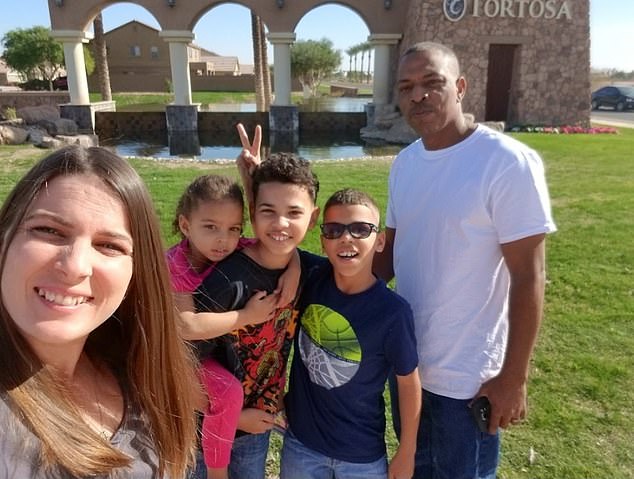 Mrs. Pratt is pictured above with her family. She said she was hospitalized for three days after battling the illness for two weeks.