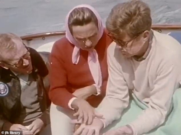 Among those appearing in the film was JFK's good friend Red Fay (left), who originally insisted that he was the only one killed in the film. His wife is seen reading the then-president's palm aboard their yacht, the Honey Fitz.