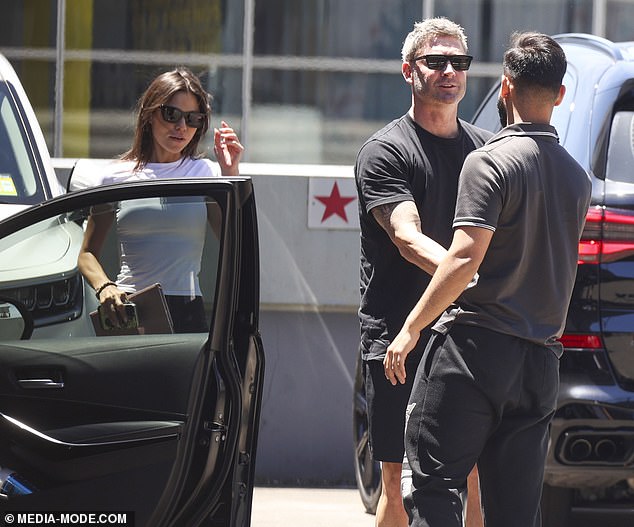 Errands completed, the couple later returned to the parking lot, where Michael stopped to shake hands and chat with an unidentified man, possibly a fan.