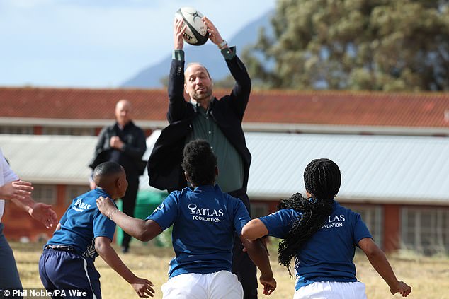 The prince jumps to catch the ball during his visit to Ocean View High School