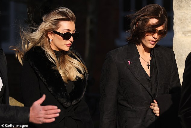 Kate, dressed in a long black coat with fur trim and sunglasses, looked somber as she entered the church with her friend.