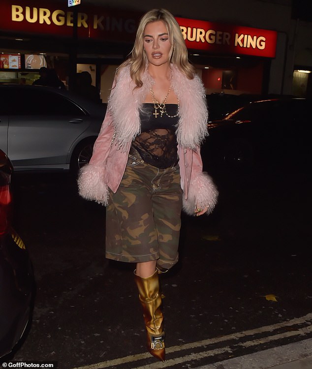 Megan turned heads in a pair of baggy camouflage shorts and a sheer lace top during her latest night out in London.