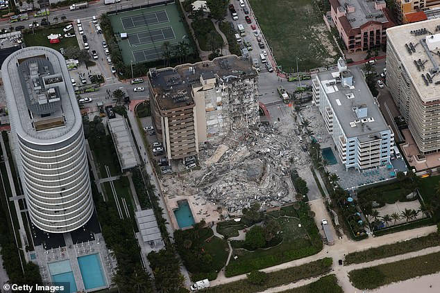 Pictured: The aftermath of an apartment building collapse in Surfside, Florida. The disaster has prompted state lawmakers to more heavily regulate condos, having a devastating effect on the market