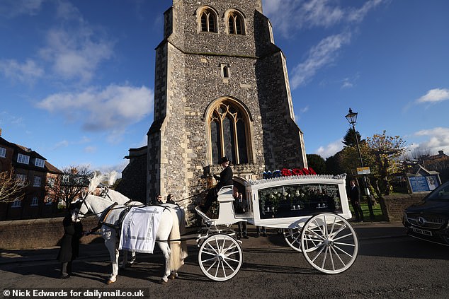 Payne's coffin stands outside the flint-covered church on a clear but cold day in the Home Counties