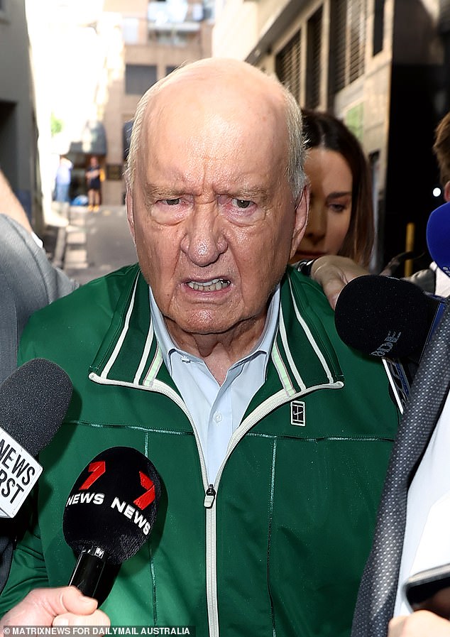 Jones is photographed wearing a tangled emerald green ensemble in front of a waiting group of media as he left the Day Street police station on Monday afternoon.