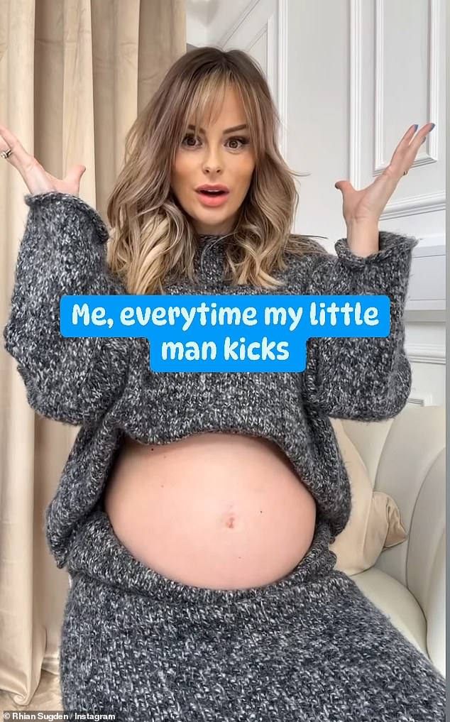 Rolling up her gray sweater sleeves, the star rubbed her belly as she gushed about her energetic baby boy. 'The baby is getting stronger every day!'