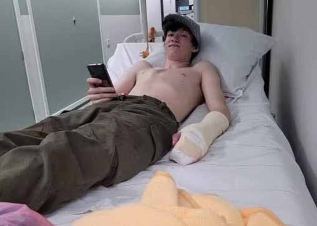 Evert is seen lying in a hospital bed shortly after undergoing surgery on his arm.