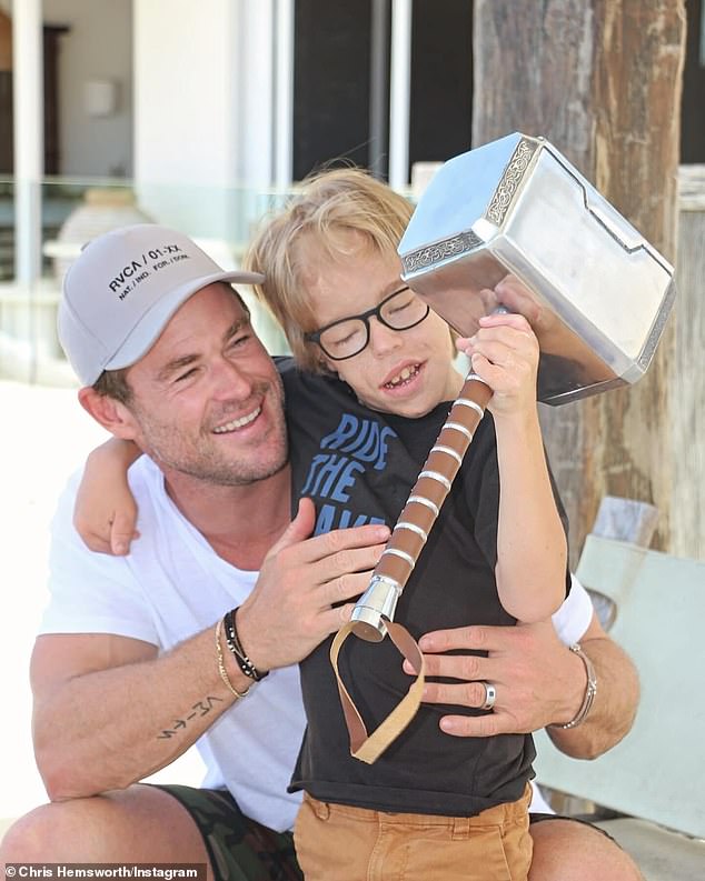 The Thor star took time out of his busy schedule to shed light on a very special child.  In one image, Chris hugs Amon as he shows off his amazing strength by wielding the Norse god's famous hammer, Mjölnir.  In the photo