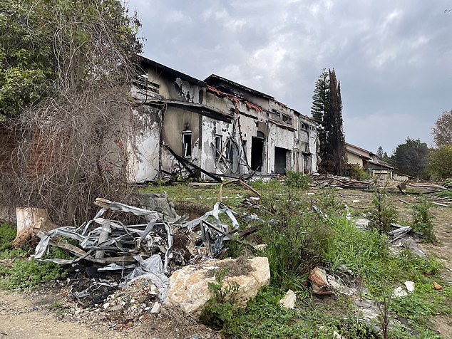 Another house is seen on Wednesday at Kibbutz Be'eri, which was left uninhabitable after the October 7 attack. The walls are blackened and the roof has suffered serious damage.