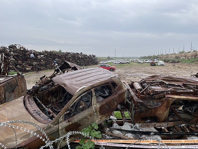 Cars destroyed in the October 7 attack are seen piled up near Kibbutz Be'eri on Wednesday