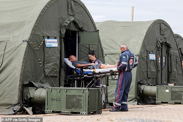 A patient is taken to a hospital after receiving medical attention at a makeshift military aid post set up to treat suspected cases of dengue in Brazil, February 6.