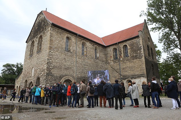 Visitors stand in front of the Burchardi Church to experience the John Cage Halberstadt Organ Foundation sound change inside the Burchardi Church in Halberstadt, Germany, on Saturday, September 5, 2020.