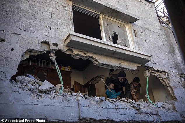Palestinians watch the destruction after an Israeli attack in Rafah, southern Gaza Strip, Thursday, Feb. 8, 2024. (AP Photo/Fatima Shbair)