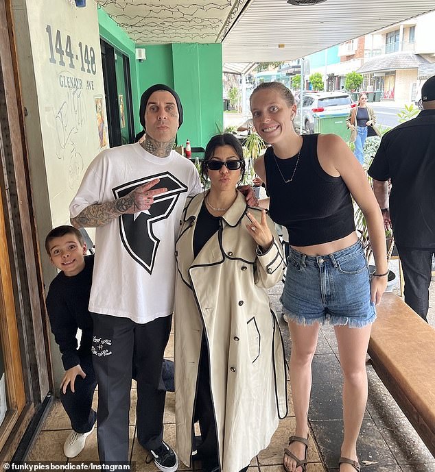 The couple have been seen exploring Bondi and posing with fans (right) as they make the most of their stay in Sydney with Rocky, three months, and Kourtney's children Penelope, 11, and son Reign, eight .