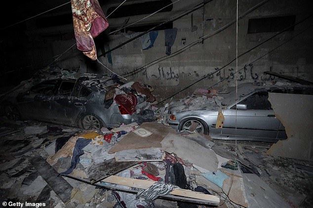 People inspect damage to their homes following Israeli airstrikes on February 9 in Rafah, Gaza.