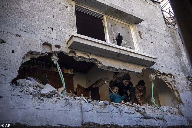 Palestinians watch the destruction following an Israeli attack in Rafah, in the southern Gaza Strip.