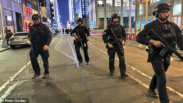 Heavily armed police patrol Times Square with the shooter still at large.