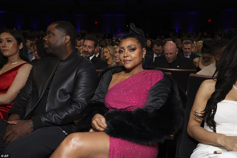 Taraji looked stunning in a bright pink dress with an off-the-shoulder design as she wrapped herself in a fur-trimmed jacket.