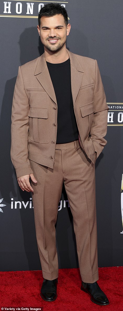 Taylor Lautner kept it stylish in a tan suit