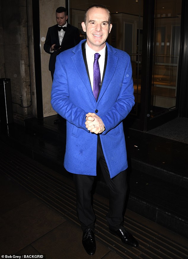 Martin, 51, famous for his namesake Money Show, wore a bright blue coat with a black suit and purple tie and shiny black shoes.