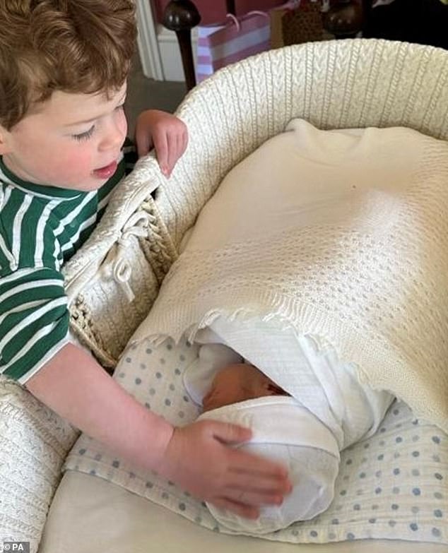 Pictured: Princess Eugenie's eldest son August places a loving hand on his little brother Ernest in June 2023.