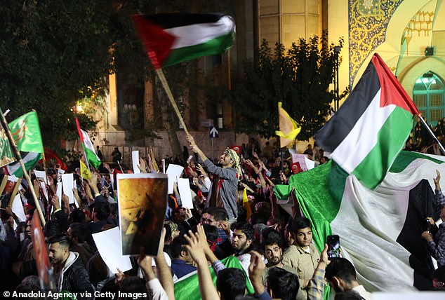 Thousands of Iranians hold a rally and carry a Palestinian flag in support of Hamas and the Palestinian resistance in Tehran, Iran, on October 7.