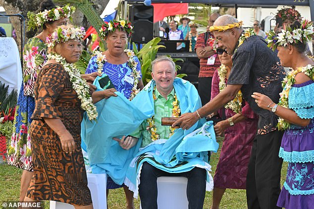 Albanese seemed unconcerned as he mingled with the people of the Cook Islands.