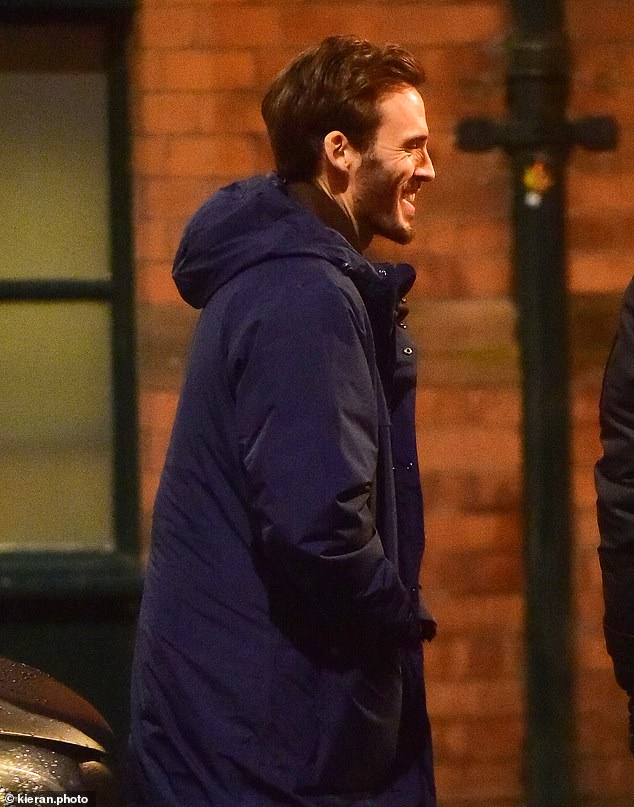 The Hunger Games alum was then captured smiling on the street, ditching his stylish coat for a navy puffer jacket.