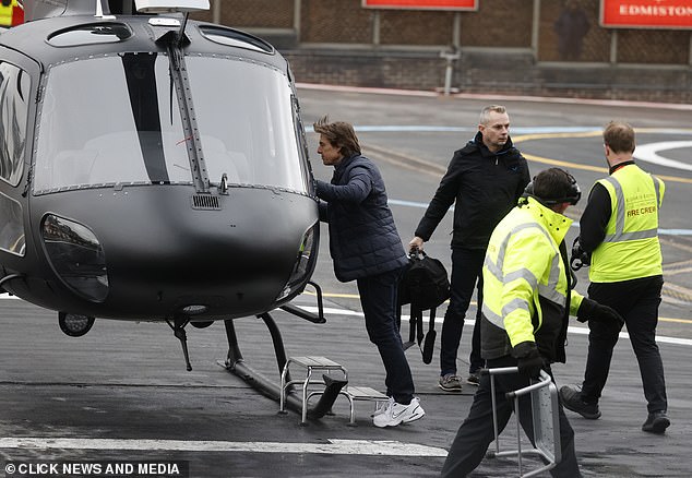 Tom piloted the matte black helicopter himself and landed on the helipad.