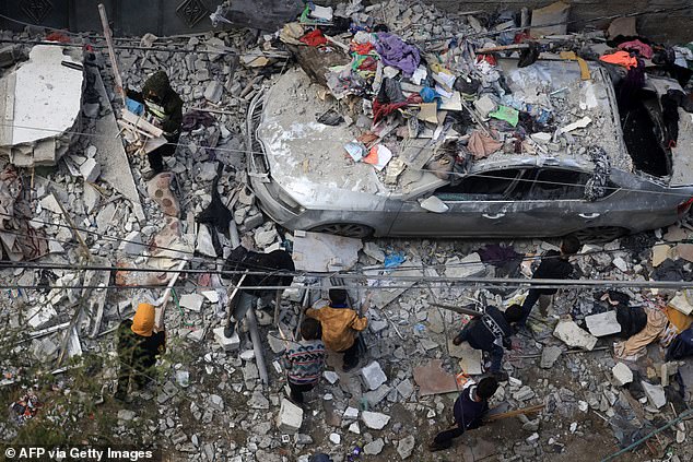 People assess the damage caused by Israeli bombing in Rafah in the southern Gaza Strip on Friday.