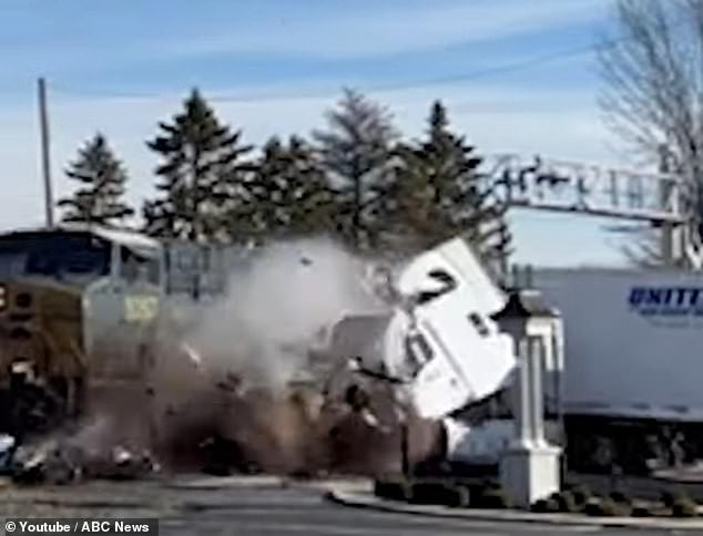 Just seconds later, the train collided with his vehicle, engulfing him in a cloud of smoke as the cabin shattered, scattering debris in all directions.