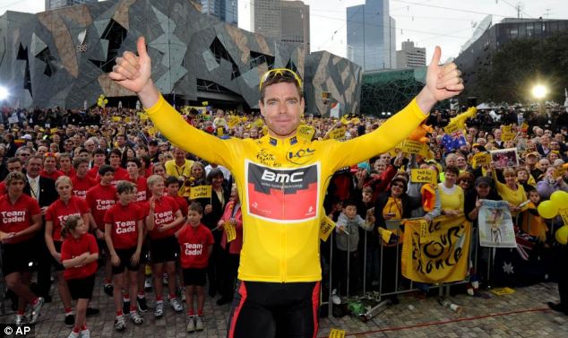 Bagging the yellow jersey: Cadel Evans dazzled the crowd with an acceptance speech in French and English when he won the Tour de France in 2011.