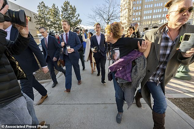 Chrystina Page, right, holds back Heather De Wolf, yelling at Jon Hallford, left, as she leaves with her attorneys after a preliminary hearing, Thursday, Feb. 8, 2024.