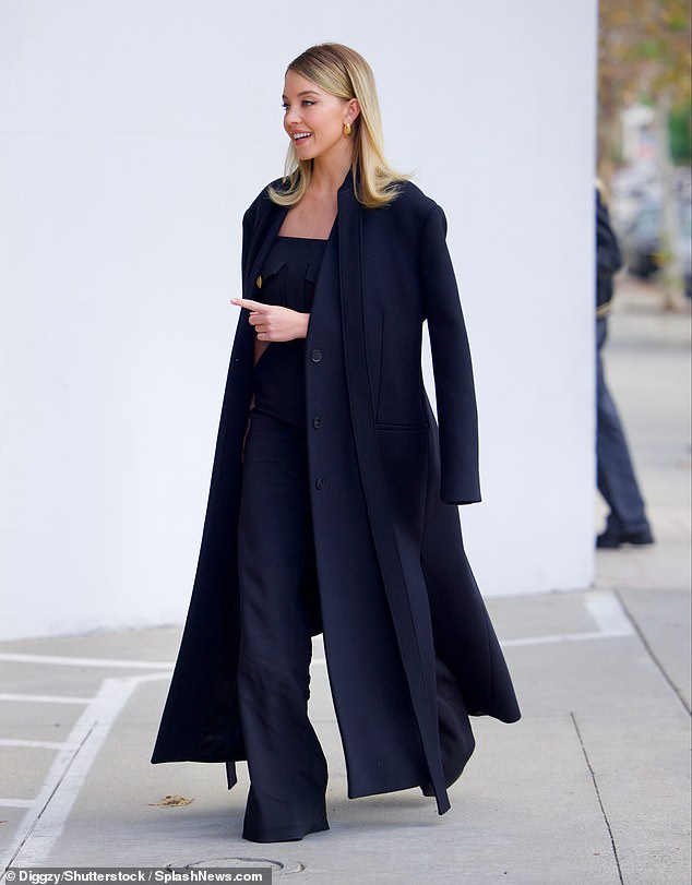 The actress, who is currently promoting her upcoming film Madame Web, wowed in a sophisticated black jumpsuit with a matching coat draped over her shoulders.