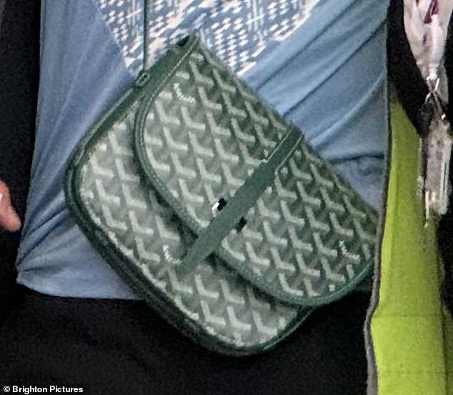 The 21-year-old son of fashion designer Victoria and retired footballer David Beckham was seen wearing the green and white garment hanging from a cross-body strap.