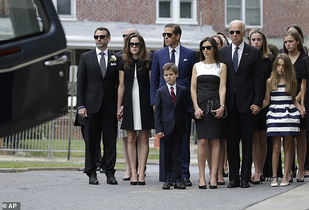 Then-Vice President Biden stands with his family near a heart before his son Beau's funeral on June 6, 2015. Beau Biden died of a brain tumor at the age of 46.