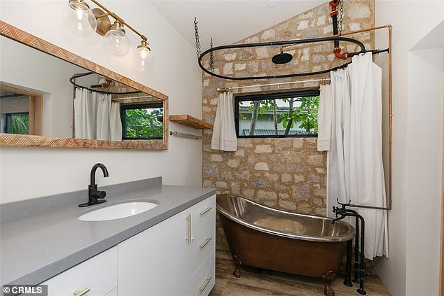 One of the bathrooms with a freestanding bathtub is located right near the living room and master bedroom. Its wide mirror makes it easy for two people to get ready in the morning, even though there is only one sink.