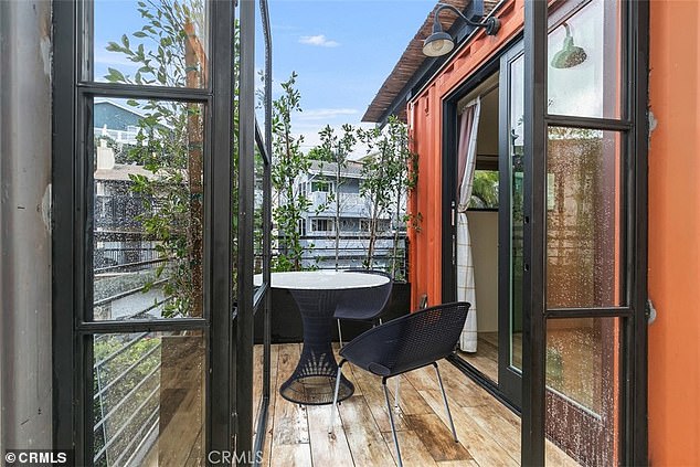 The second floor balcony overlooks the neighborhood, while the trees that line the property offer privacy.