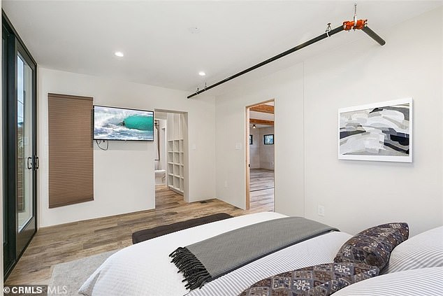 The master bedroom has a walk-in closet and there is also a rear balcony with a corrugated roof overlooking the neighborhood. Provides great natural light to a cozy bedroom connected to the living room.