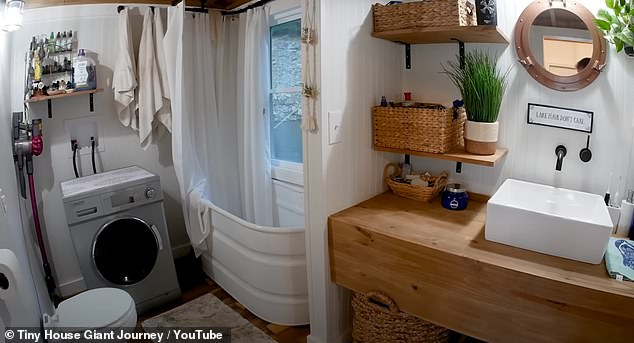 The washing machine is located next to the bathtub and the maceration toilet.