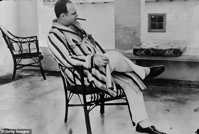 American gangster Al Capone ('Scarface') (1899 - 1947) relaxes at his vacation home, Miami, Florida, 1930: the house where the empty lot now stands