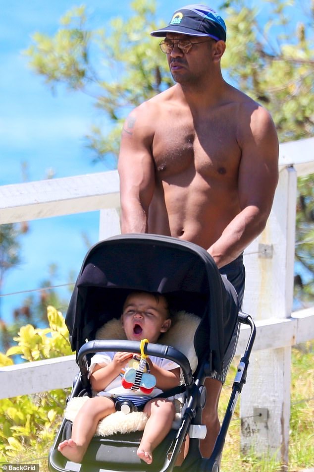 Beale, pictured taking his son, also named Kurtley Beale, for a walk, and his wife Maddie will welcome their second child in May.