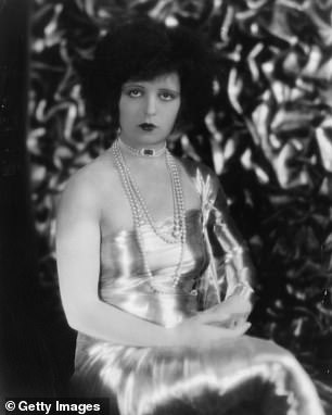 When it came to accessorizing Schiaparelli's striking white dress, the beauty sported sparkling silver necklaces and a shiny black watch.  Clara had also worn a watch as a necklace along with pearls while she posed for a photo around 1925 (seen above).
