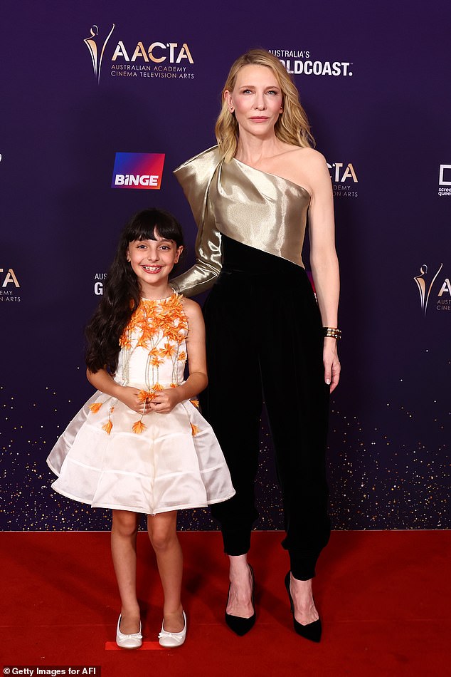 Cate let the unique ensemble do the talking by accessorizing it with a gold bracelet and slipping on matching black suede stilettos.