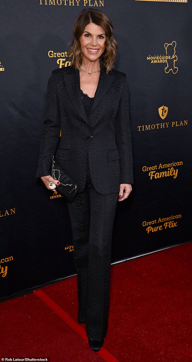 Lori, 59, looked elegant in a black printed suit with a low-cut lace top and black satin pumps.