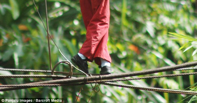 Children risk a 30-foot fall when they cross the river each morning before going to school.