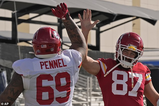 Tight end Kelce high-fives defensive tackle Mike Pennel Jr. as they wrap up their preparations